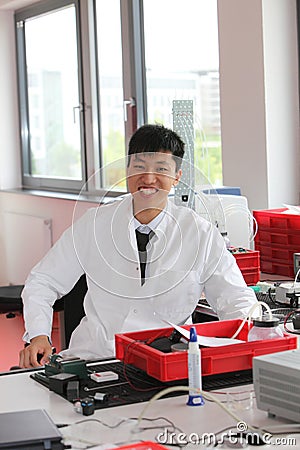 Smiling Asian man working in a laboratory