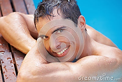 Smiling attractive man in swimming pool
