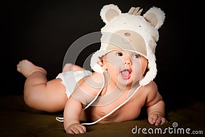 Smiling baby in bear cap