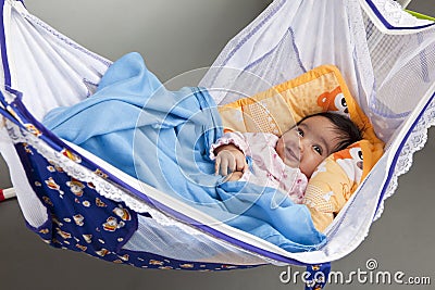 Smiling Baby in a Hammock-Style Cradle