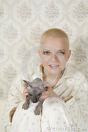 Smiling bald woman with cat