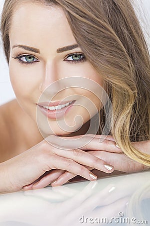 http://thumbs.dreamstime.com/x/smiling-beautiful-woman-resting-hands-portrait-blond-young-green-eyes-her-36525687.jpg