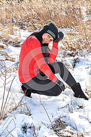 Smiling beautiful young woman relaxing outdoor in a winter day