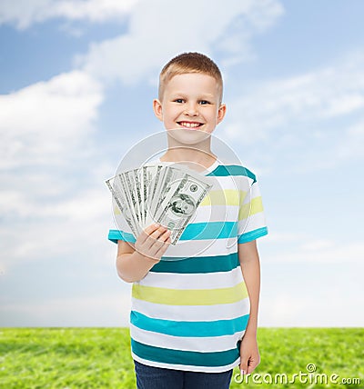 Smiling boy holding dollar cash money in his hand