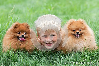 Smiling boy with two dogs