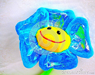 Smiling bright blue yellow toy flower