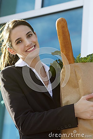 Smiling business woman with groceries