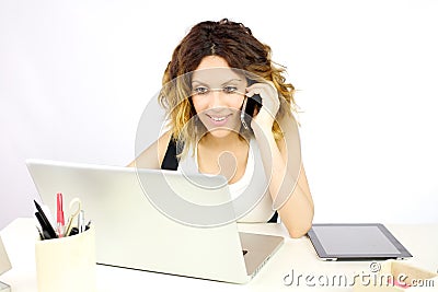 Smiling business woman working with pc talking on the phone