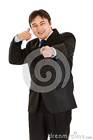 Smiling businessman showing contact me gesture