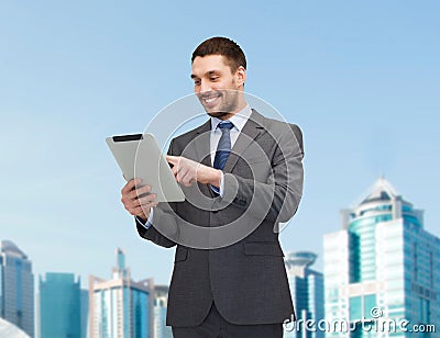 Smiling businessman with tablet pc computer