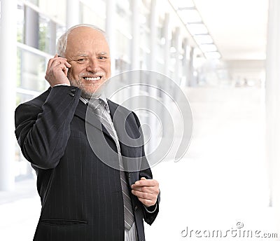 Smiling businessman using mobile phone