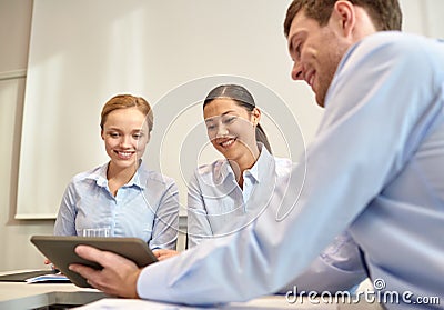 Smiling businesspeople with tablet pc in office