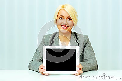 Smiling businesswoman woman showing display of a tablet computer