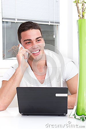 Smiling casual handsome man using mobile
