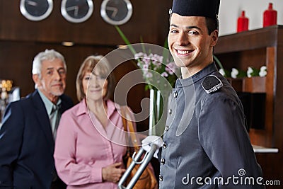 Smiling concierge with senior couple