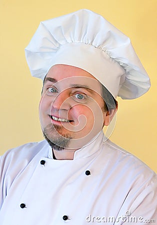 Smiling cook chef on yellow