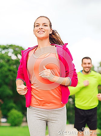 Smiling couple running outdoors