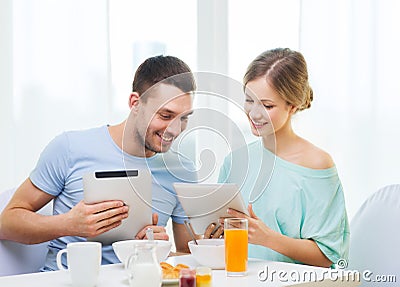 Smiling couple with tablet pc reading news