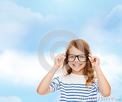 Smiling cute little girl with black eyeglasses