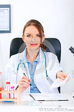 Smiling doctor woman giving medical prescription