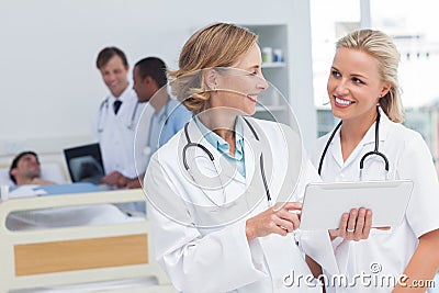 Smiling doctors talking to each other