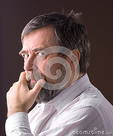 Smiling elderly man on a brown background