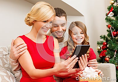 Smiling family with tablet pc