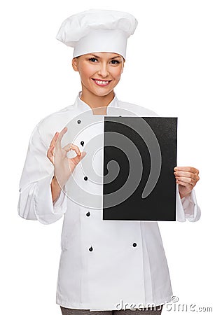 Smiling female chef with black blank paper