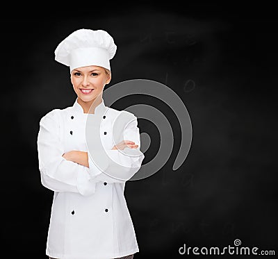 Smiling female chef with crossed arms