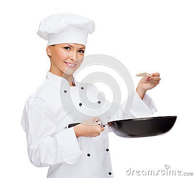 Smiling female chef with pan and spoon