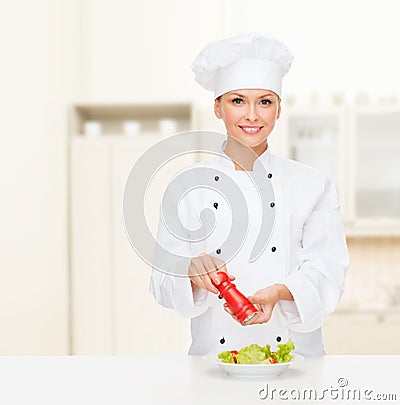 Smiling female chef with preparing salad