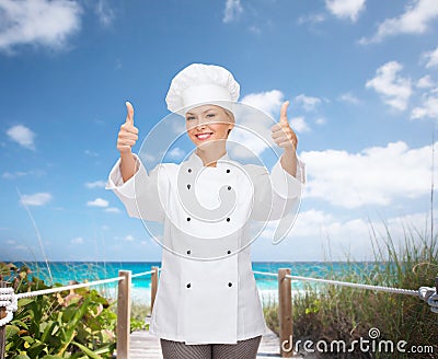 Smiling female chef showing thumbs up