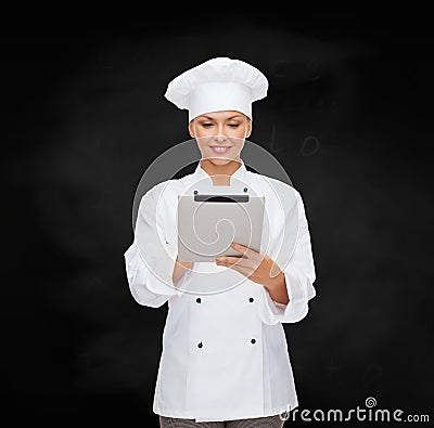 Smiling female chef with tablet pc computer