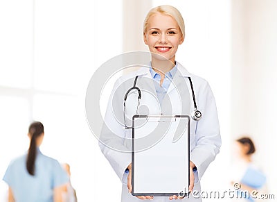Smiling female doctor with clipboard