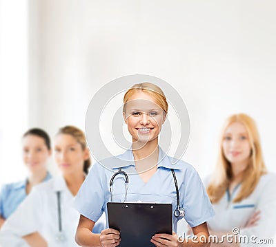 Smiling female doctor or nurse with clipboard