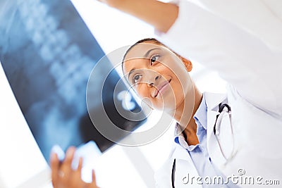 Smiling female doctor studying x-ray