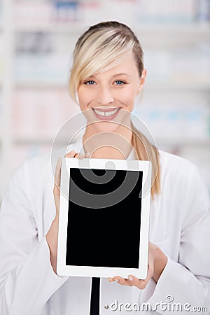 Smiling female pharmacist holding a blank tablet