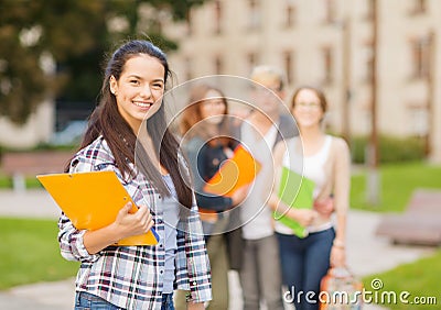 Smiling female student with folders