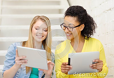 Smiling female students with tablet pc computer