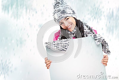 Smiling girl with a blank board and around snowing