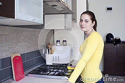 Smiling girl cleaning on the kitchen