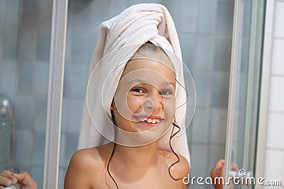 A smiling girl with a towel on his head