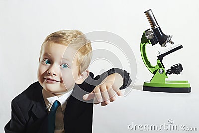 Smiling little boy in tie.funny child.Schoolboy working with microscope.Smart kid