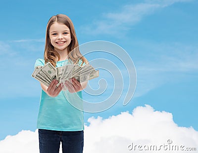 Smiling little girl giving dollar cash money