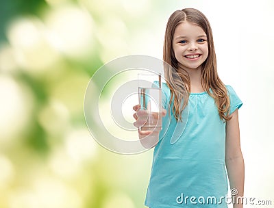 Smiling little girl giving glass of water