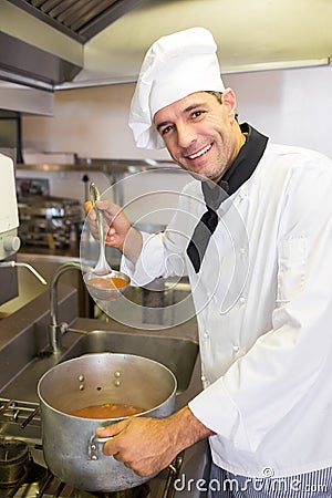 Smiling male chef preparing food in kitchen