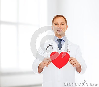 Smiling male doctor with red heart and stethoscope