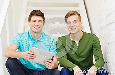 Smiling male students with tablet pc computer