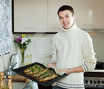 Smiling man with cooked fish