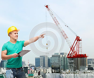 Smiling man in helmet with clipboard